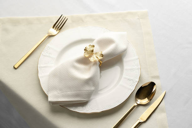 istock Gold Leaf Napkin Ring on White Plate and Placemat 2162360751