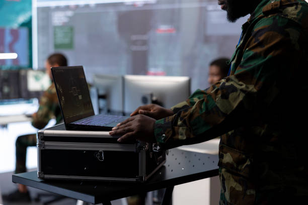 istock Government intelligence expert works on laptop in a command center 2162363595