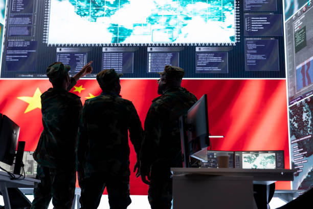 Military intelligence officers analyze surveillance on big screen
