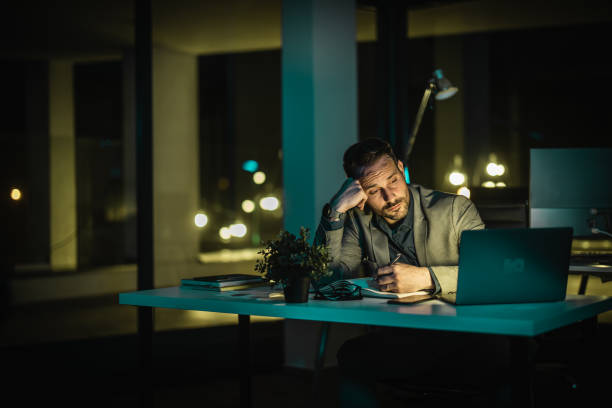 istock Late-Night Broker-Exhausted but Determined 2162365281