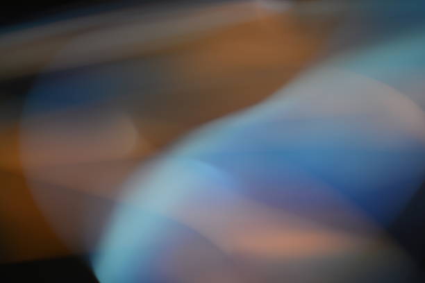 light trails in a long exposure shot. The image features a blend of warm and cool tones, creating a mesmerizing and dynamic visual effect. Perfect for use in artistic and creative projects