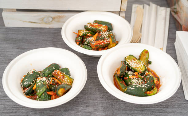 Cucumber kimchi, oi sobagi, or Korean cucumber pickle in bowls. Oi kimchi, with sesame seeds, spicy cucumbers
