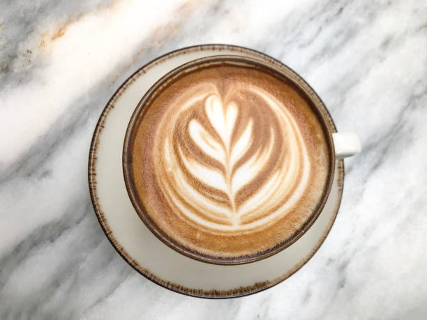 istock cappuccino coffee with latte art on marble table 2162367173