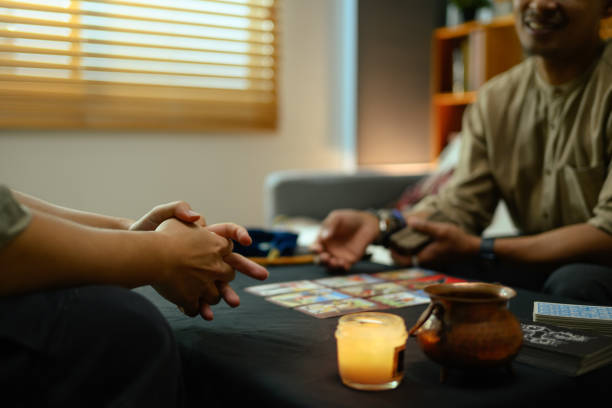 istock Unrecognizable client listening to the fortune teller while predicting future in dark room 2162368507