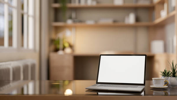 istock A laptop with a mockup screen on a modern coffee table in a cozy private office workspace. 2162368655