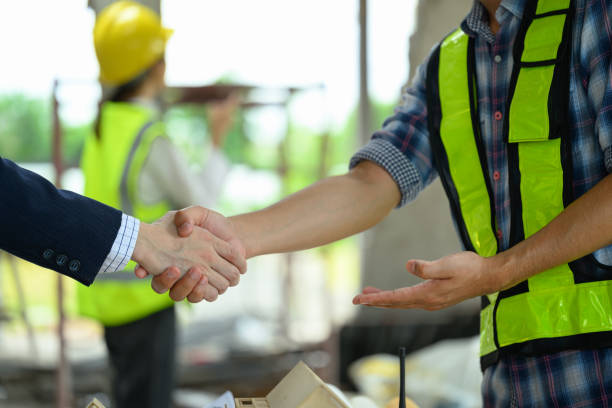 istock Male project manager and engineer shaking hands building site. Partnership and successful project 2162368838