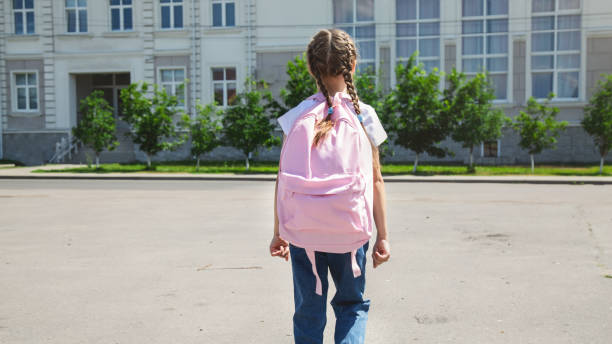 istock Little girl with backpack going to school, back view. Back to school 2162371546