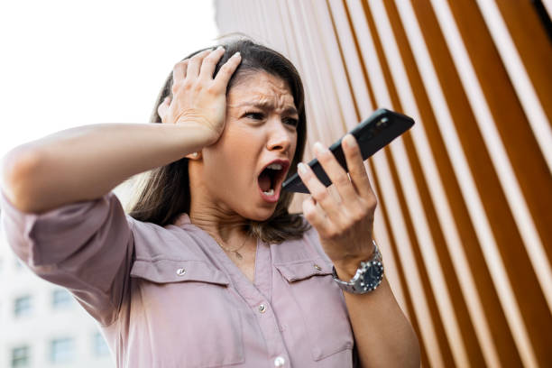 istock Frustrated Businesswoman Shouting on Phone 2162376021