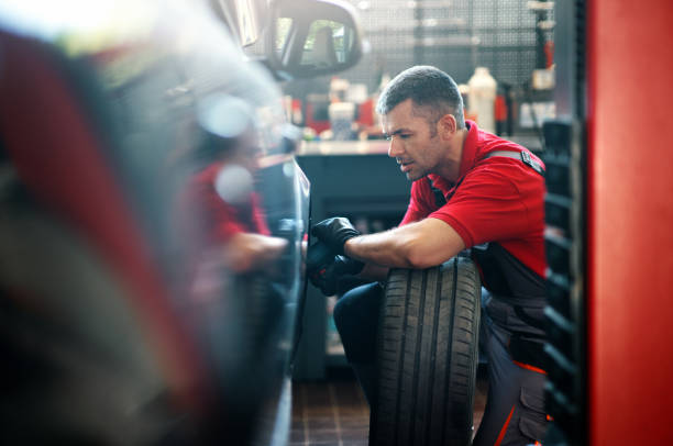 istock Car mechanic replacing a tire, 2162376199