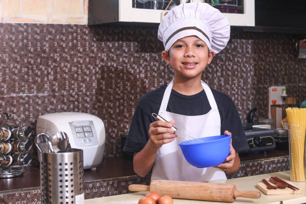istock Kid Cooking At Home 2162378317