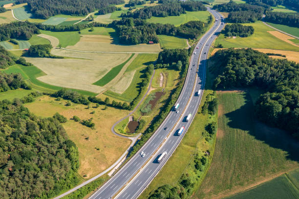 istock Highway in a green landscape 2162378635