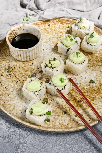 istock Sushi Roll with Wasabi Sauce and Soy Dip on Rustic Plate 2162378911