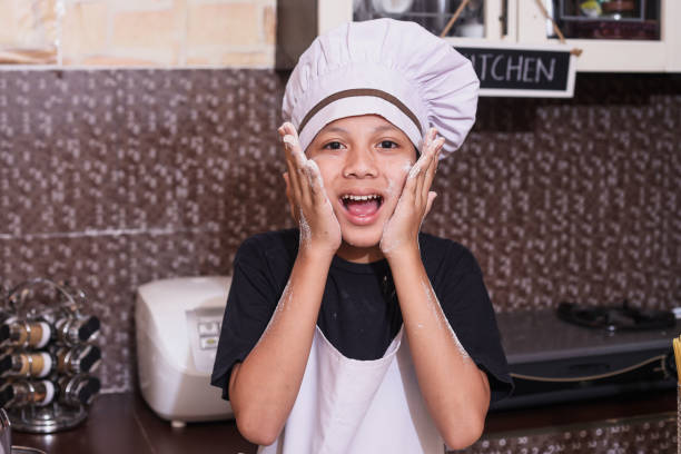 istock Kid Cooking At Home 2162380926