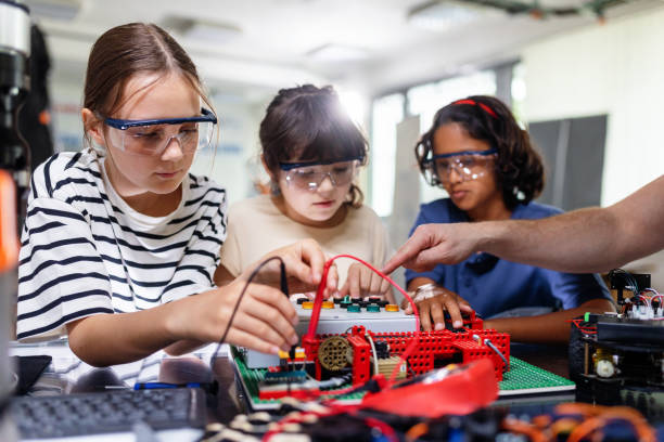 istock Classmates working togeter on circuit board, building robot in after-school robotics club. Children learning robotics in Elementary school. 2162382970