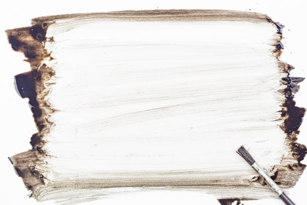 Paintbrush and paint black color on white paper background