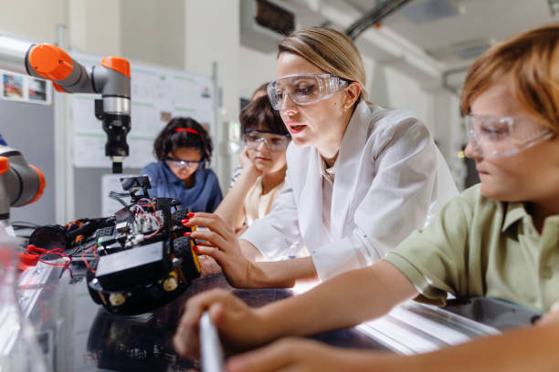 istock Children learning robotics in Elementary school. Young students building robot in after school robotics club. Field trip to real robotics laboratory. 2162383279