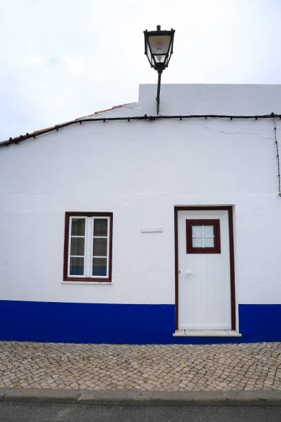 istock White wooden window with curtain on whitewashed facade 2162383330