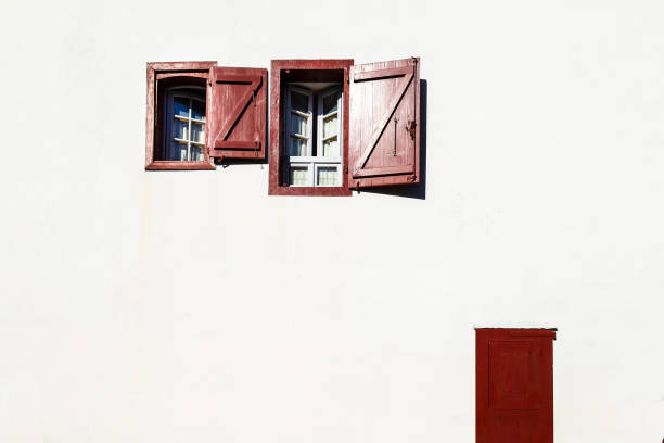 istock White wooden window with curtain on whitewashed facade 2162383862