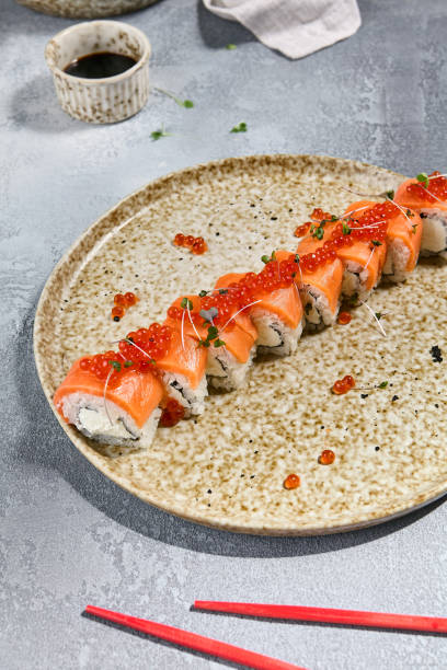 istock Salmon and Red Caviar Roll with Microgreens on a Ceramic Plate 2162384541