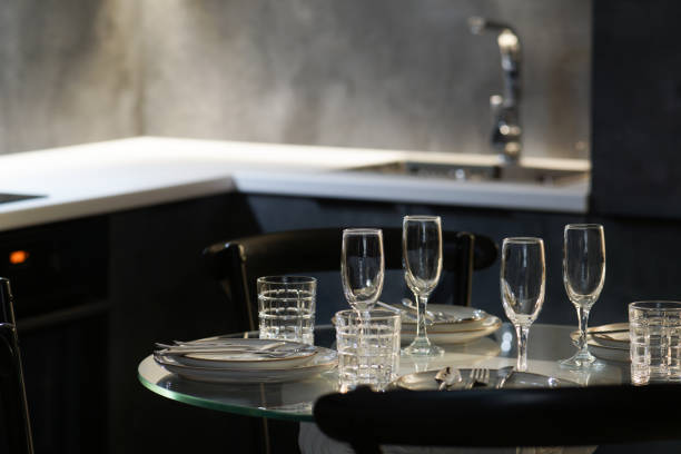 istock Close-up view of dining table set and modern kitchen in bokeh background 2162385236