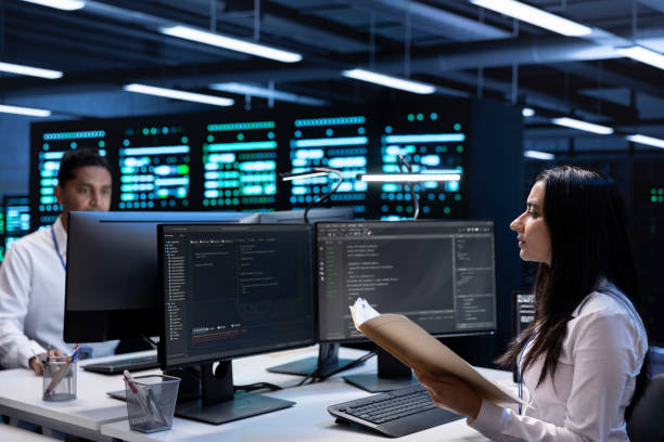 istock Team of engineers in data center checking emergency procedures documents 2162385857