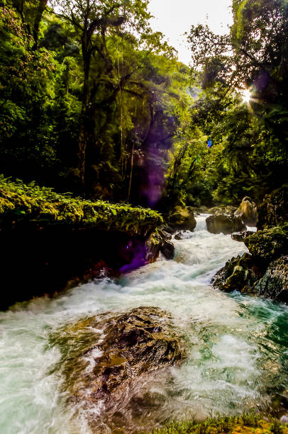 istock A river with a waterfall and a sun shining on it 2162386133