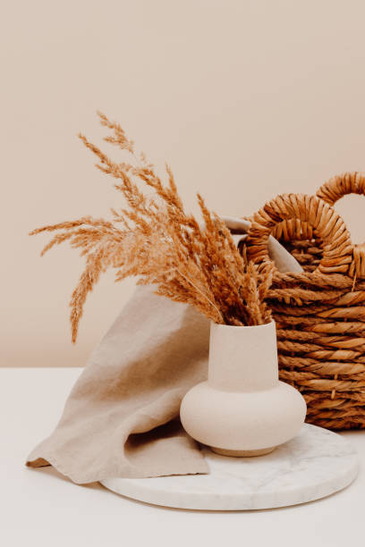 istock Cozy composition with ceramic vase on marble tray with pampas grass, linen cloth and wicker basket at the background 2162386550