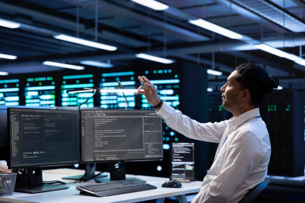 istock Developer looking at holograms in data center, monitoring infrastructure 2162386671