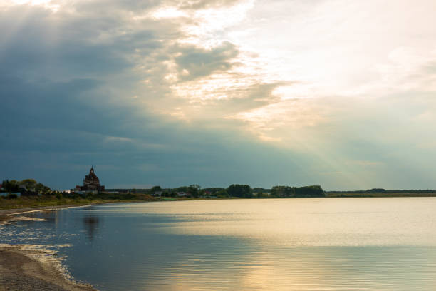 The horizon line on the lake at sunset, the church and houses on the horizon line