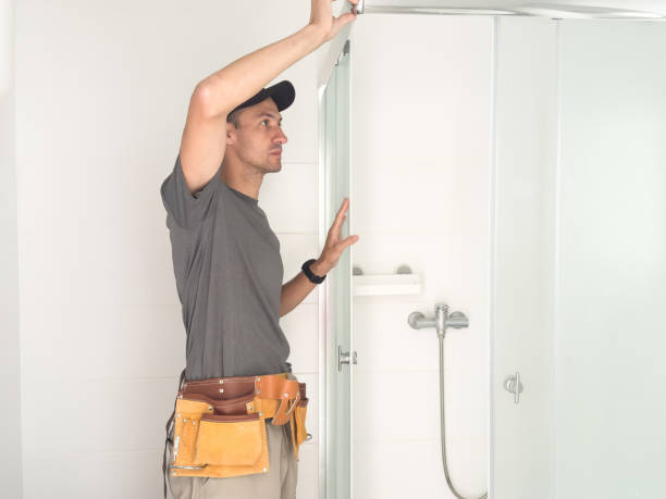 istock Plumber installing a shower cabin in bathroom 2162387282