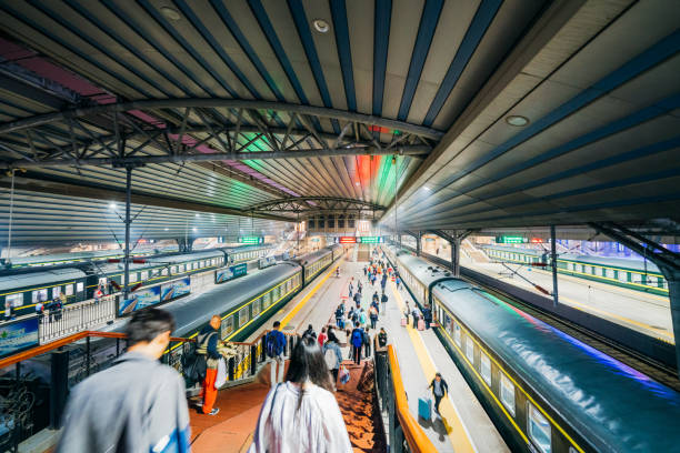 Travelers move through the bustling Beijing Railway Station in China on October 12, 2023, showcasing daily commuting life.