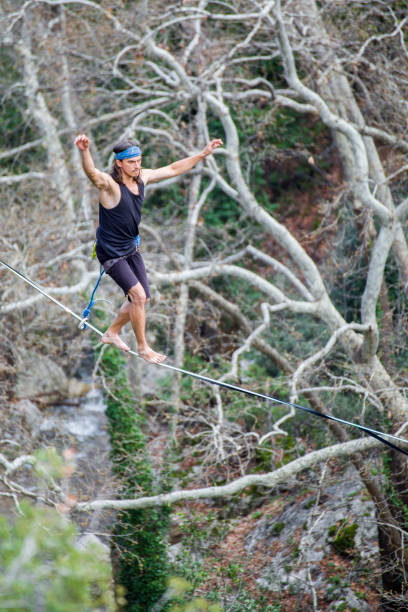 istock A man walks on a tightrope over an abyss. 2162389377