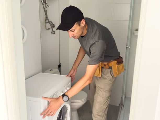 istock Plumber fixing washing machine on white background 2162390192