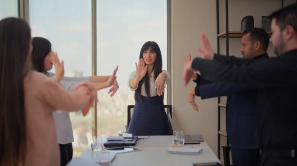 istock Business people doing stretching exercises in modern office 2162390619
