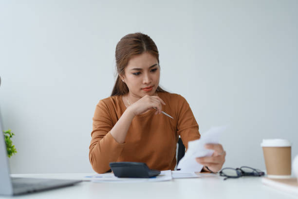 istock Smart Mortgage Planning woman using a calculator to make Calculations and Consideration 2162392327
