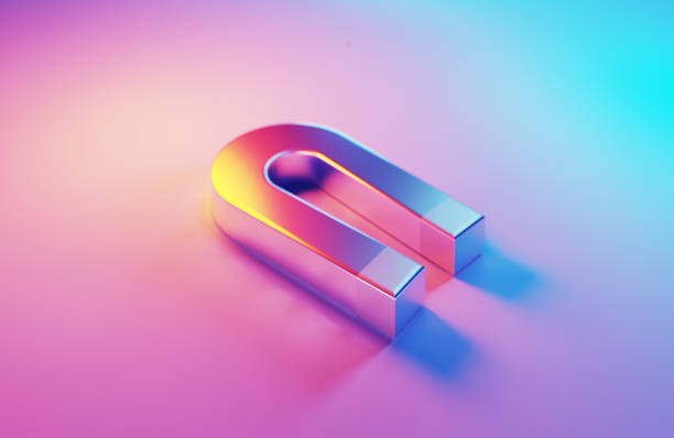 Metallic magnet which is illuminated by pink and blue light on blue background.