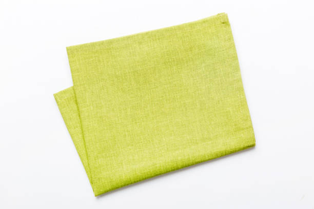 top view with green kitchen napkin isolated on table background. Folded cloth for mockup with copy space, Flat lay. Minimal style