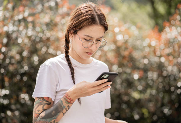 istock Young woman outdoors using her cell phone 2162398116