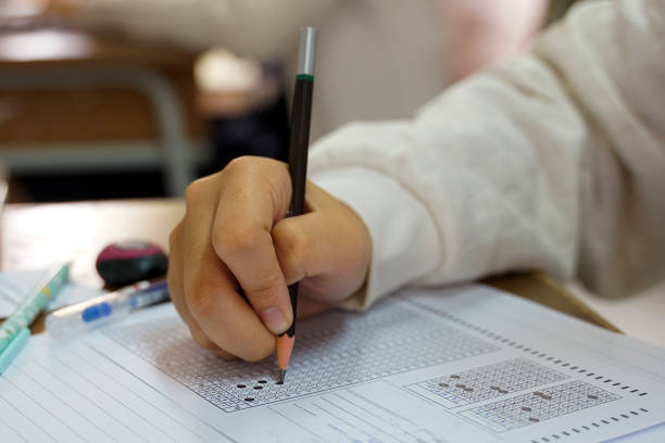 istock Asian students are taking exams to measure learning in the classroom. Soft and selective focus. 2162398862