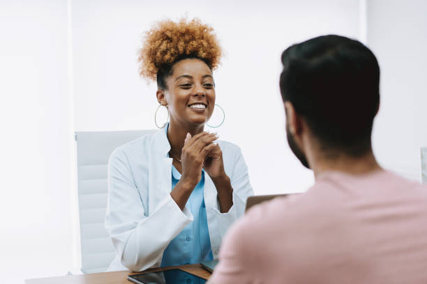 istock Doctor talking to patient in doctor's office 2162402704
