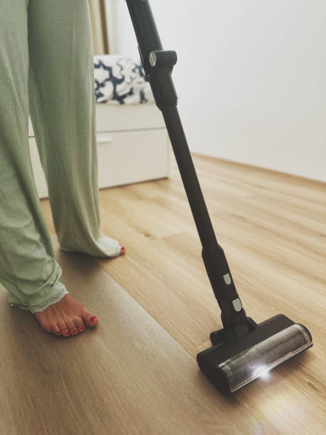istock young woman vacuuming her apartment 2162402888