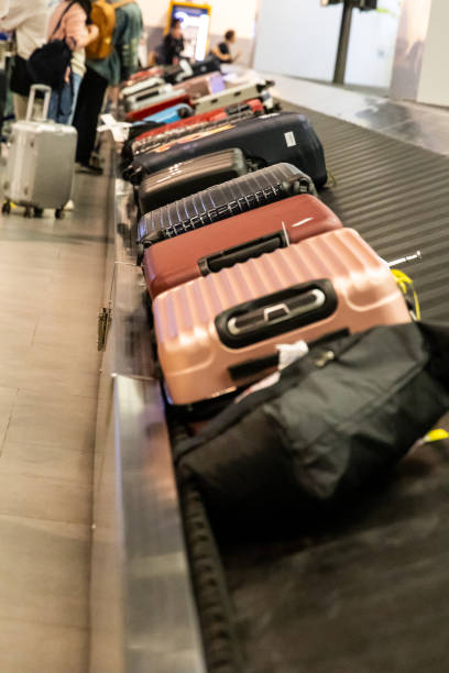 istock Passengers waiting for baggage at airport conveyor belt carousel system 2162407209