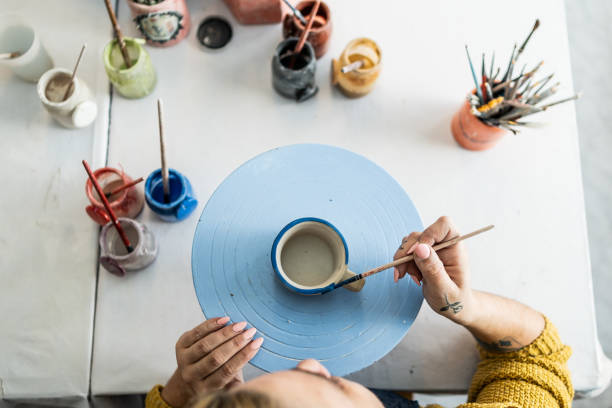 istock Woman painting a mug at ceramics workshop 2162407359