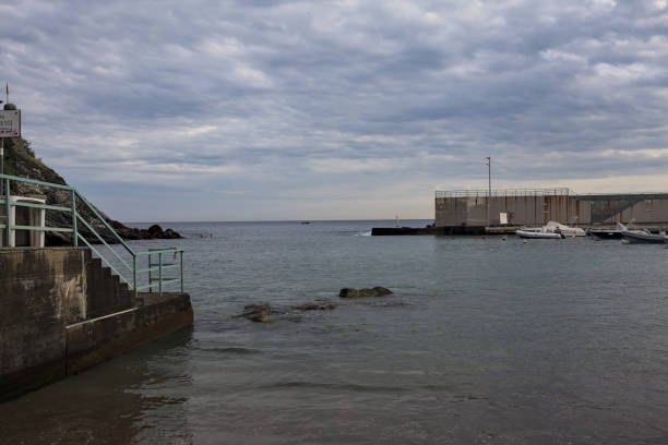 istock Bay bordered by a concrete breakwater by the sea 2162408160
