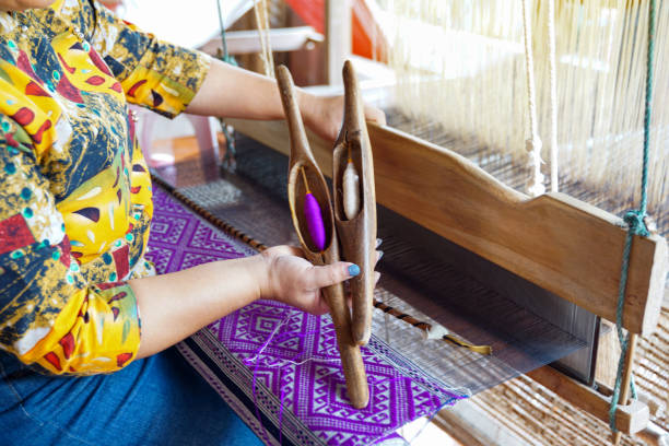 istock A weaver holding a bobbin with thread for weaving traditional patterns with a hand loom, the wisdom of villagers in the north of Thailand.soft and selective focus. 2162409988