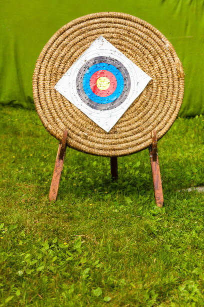 Sport competitions equipment concept. Shooting paper target and bullseye in haystack with many bullet holes