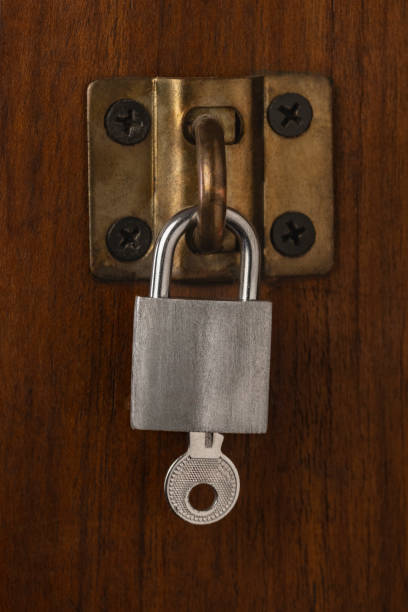 istock closed padlock on a wooden background 2162414603