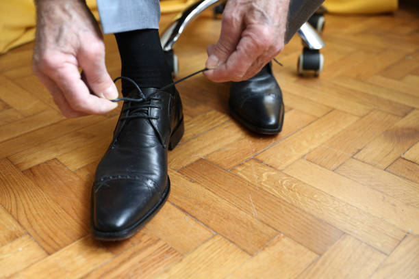 istock Senior businessman tying shoelaces 2162414894