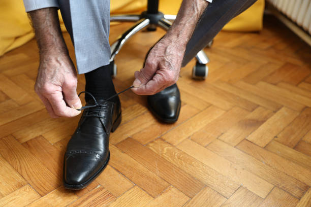 istock Senior businessman tying shoelaces 2162414899