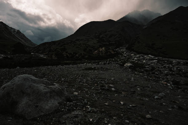 Rain clouds gathering above gloomy mountain peaks